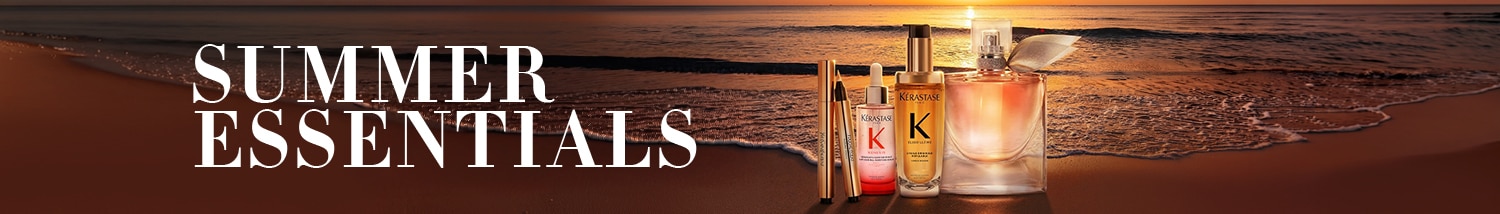 Summer Essentials Banner mit Kérastase Beauty-Produkten am Strand bei Sonnenuntergang und CTA „Jetzt entdecken“.