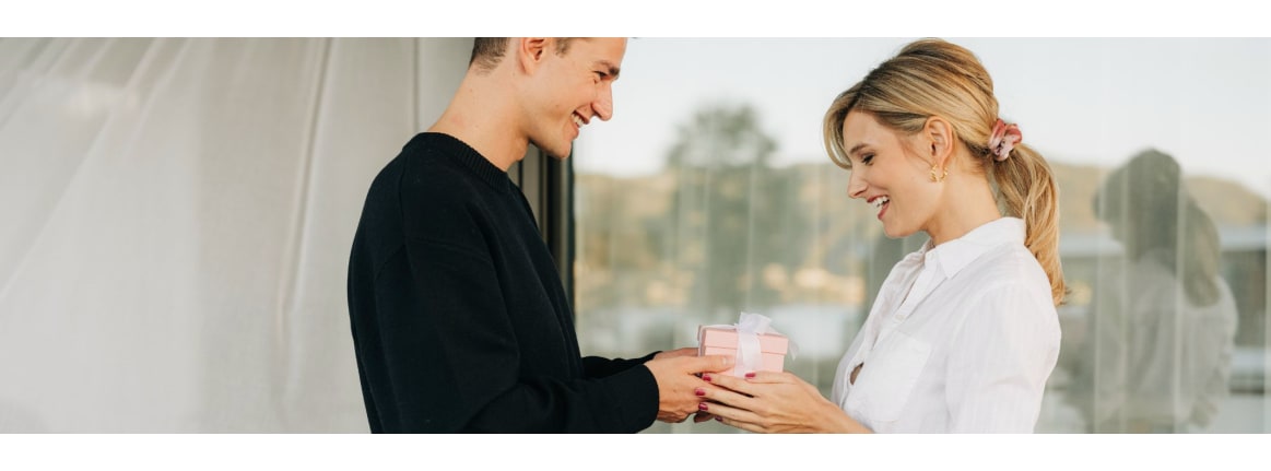 A man gives a woman a gift.